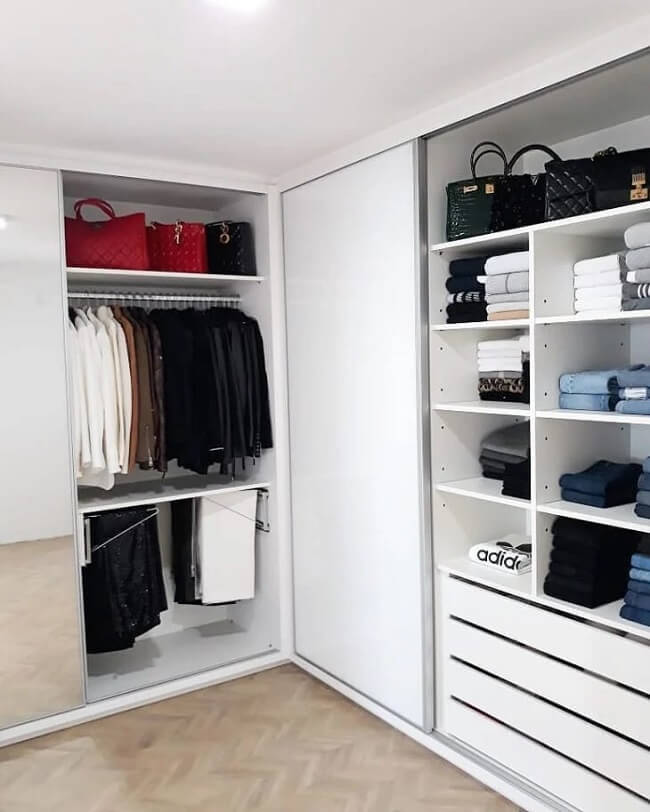 Roupas e acessórios organizados no guarda-roupa de drywall com porta de correr